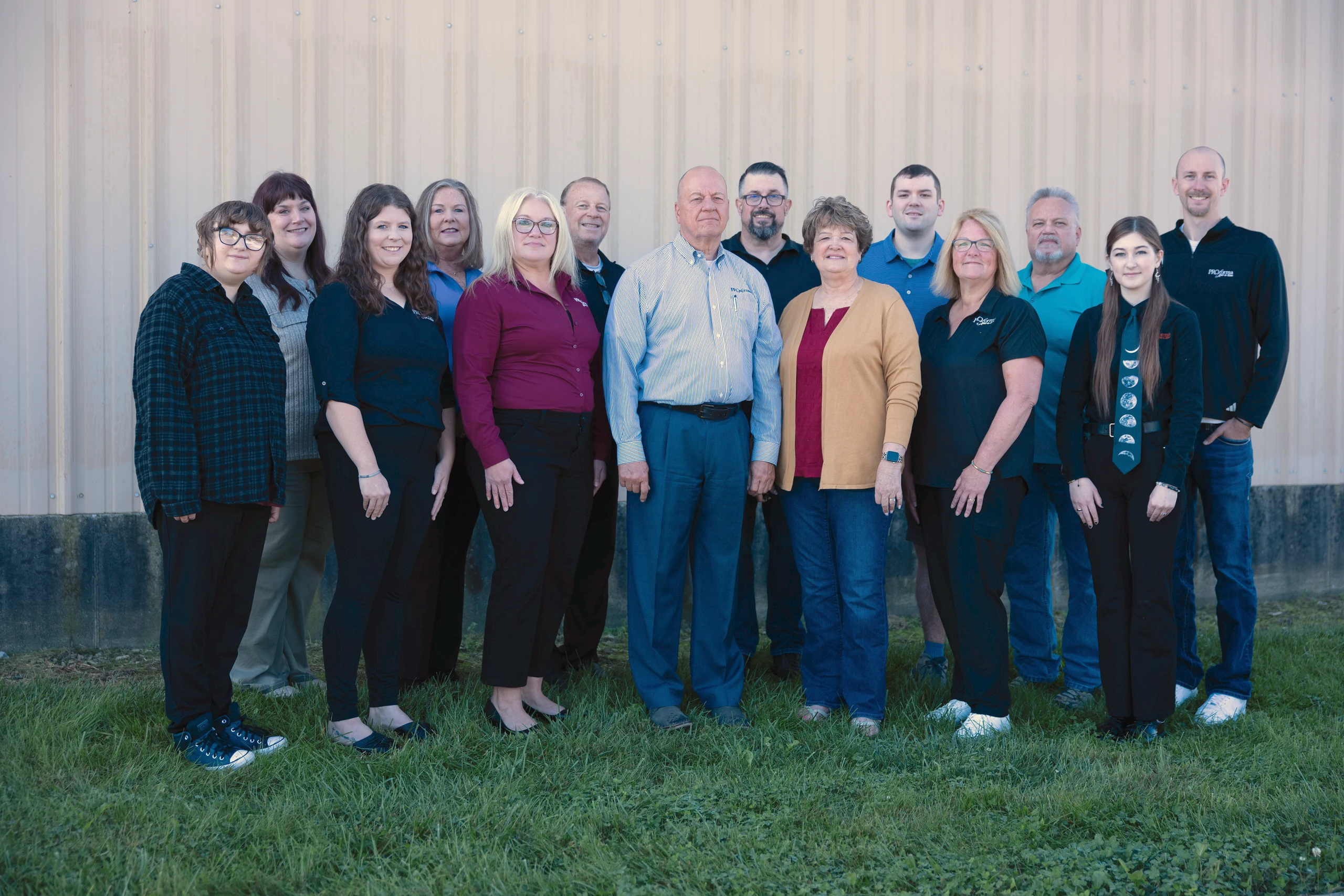 The fourteen people of the Proforma Add-a-line team standing together outside