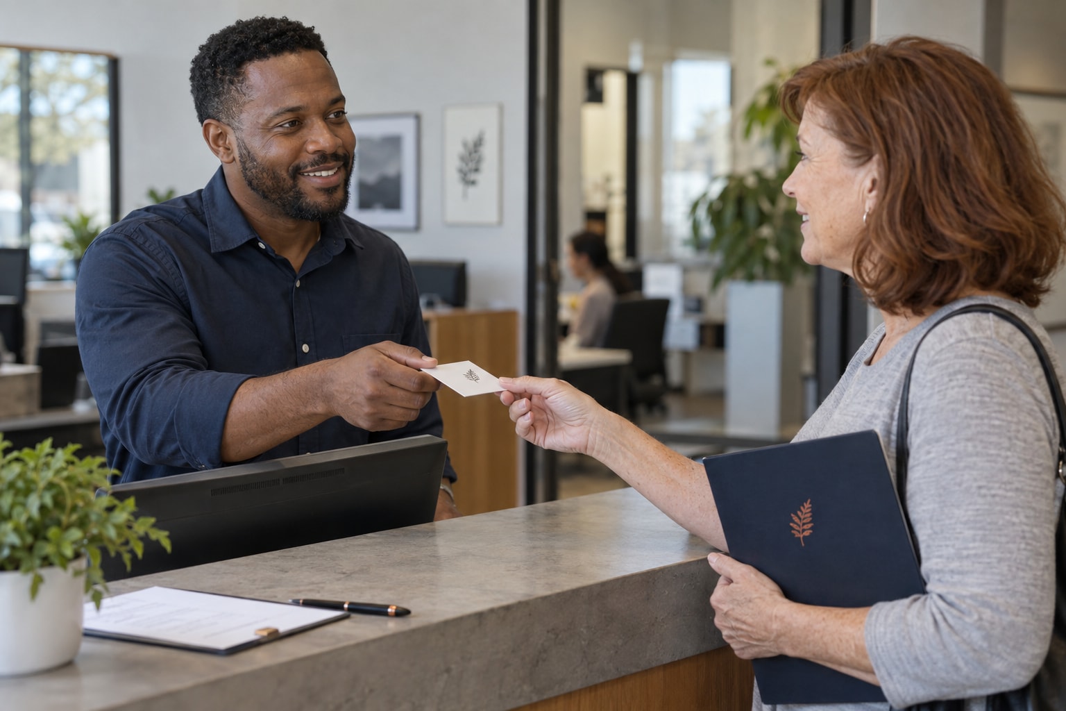 Cinematic artwork of a business card being handed across a front desk to a visitor holding a presentation folder
