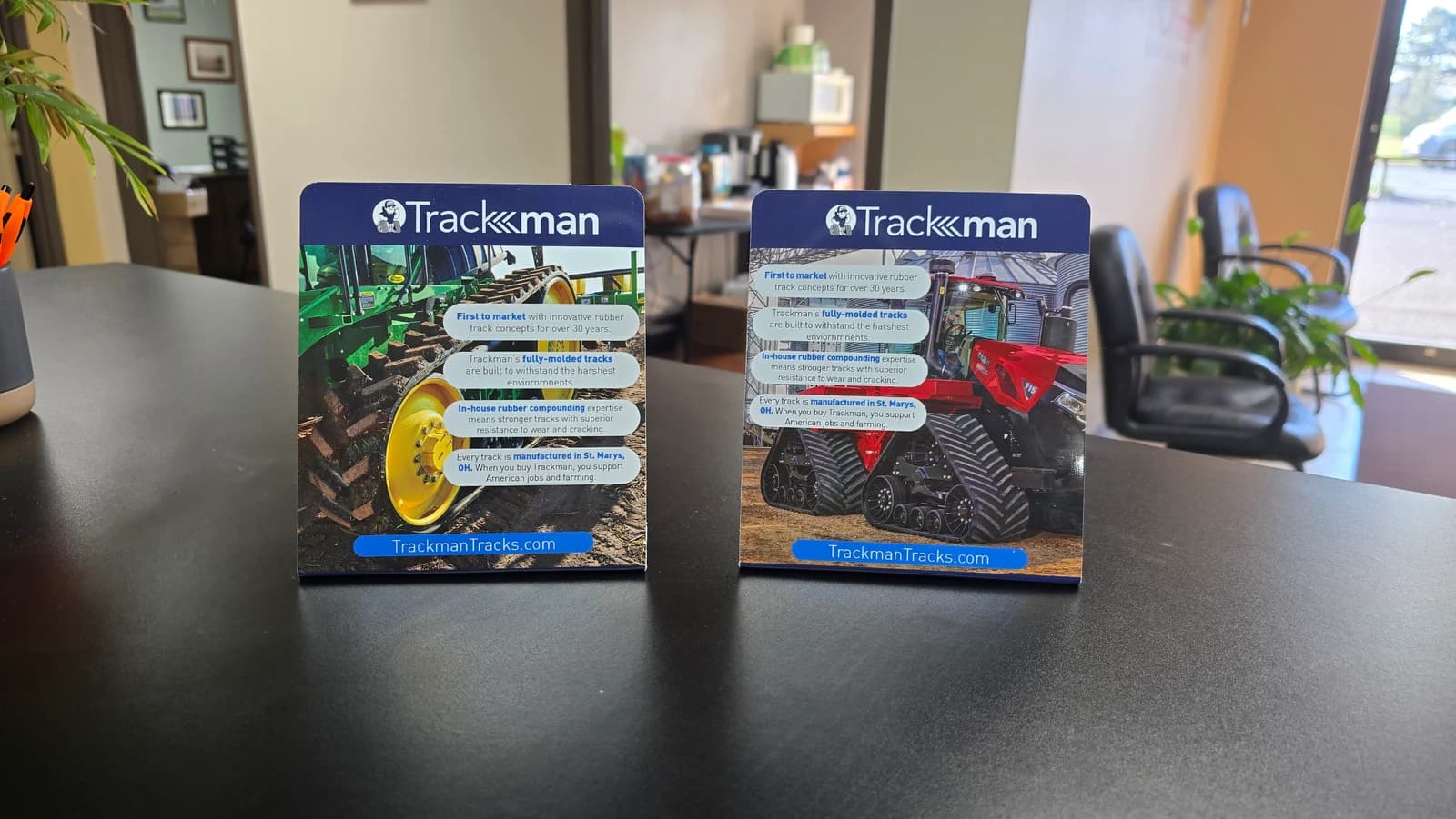 Actual completed Trackman counter displays with green and red tractor artwork on a counter