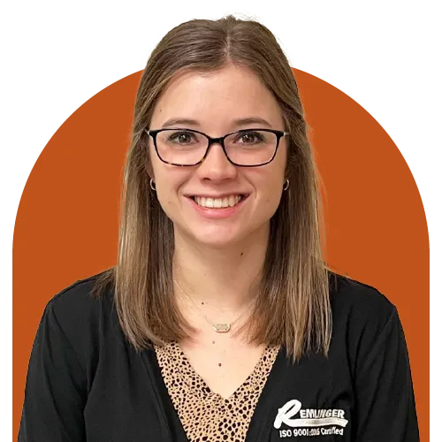 Confident professional woman with glasses wearing business attire, standing against an orange background.